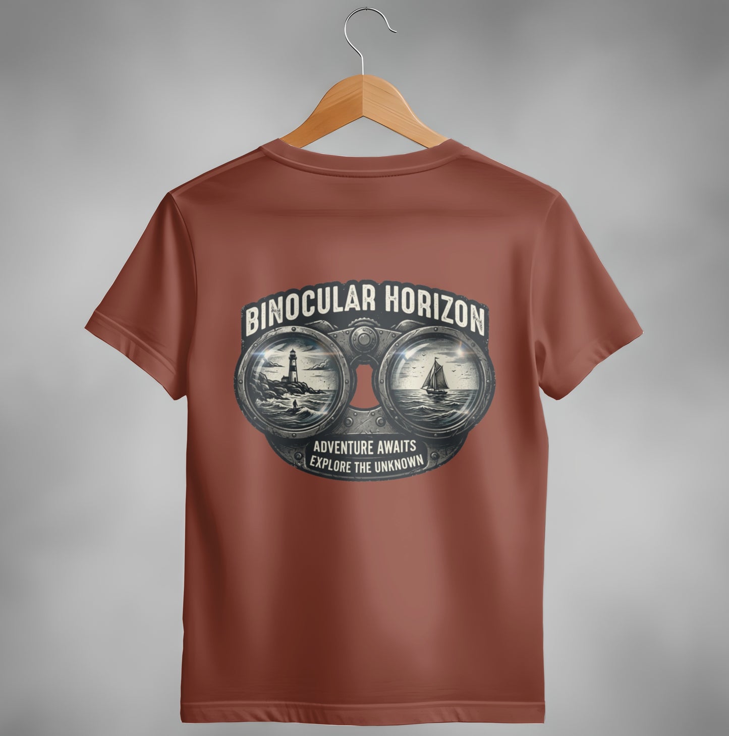 T-shirt with binoculars graphic featuring a lighthouse and sailboat, text "Binocular Horizon" and "Adventure awaits explore the unknown."
