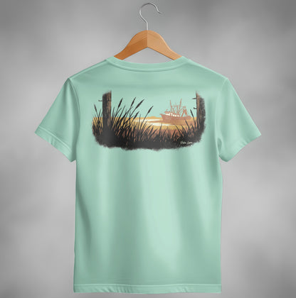 Mint green t-shirt with serene coastal artwork featuring a ship at sunset.