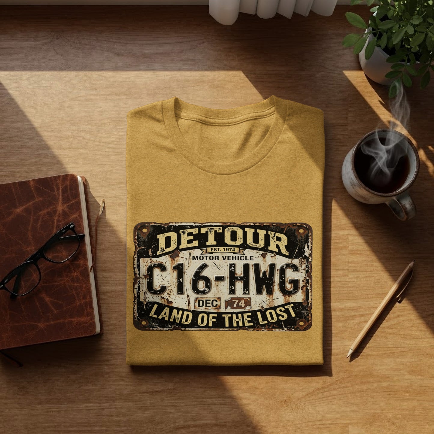 Detour 'Land of the Lost' Vintage | Vintage Outdoor Apparel: Yellow t-shirt with "Detour Motor Vehicle C16-HWG Land of the Lost" license plate graphic.