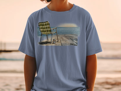 Plaid folding chair on concrete pier by the ocean.