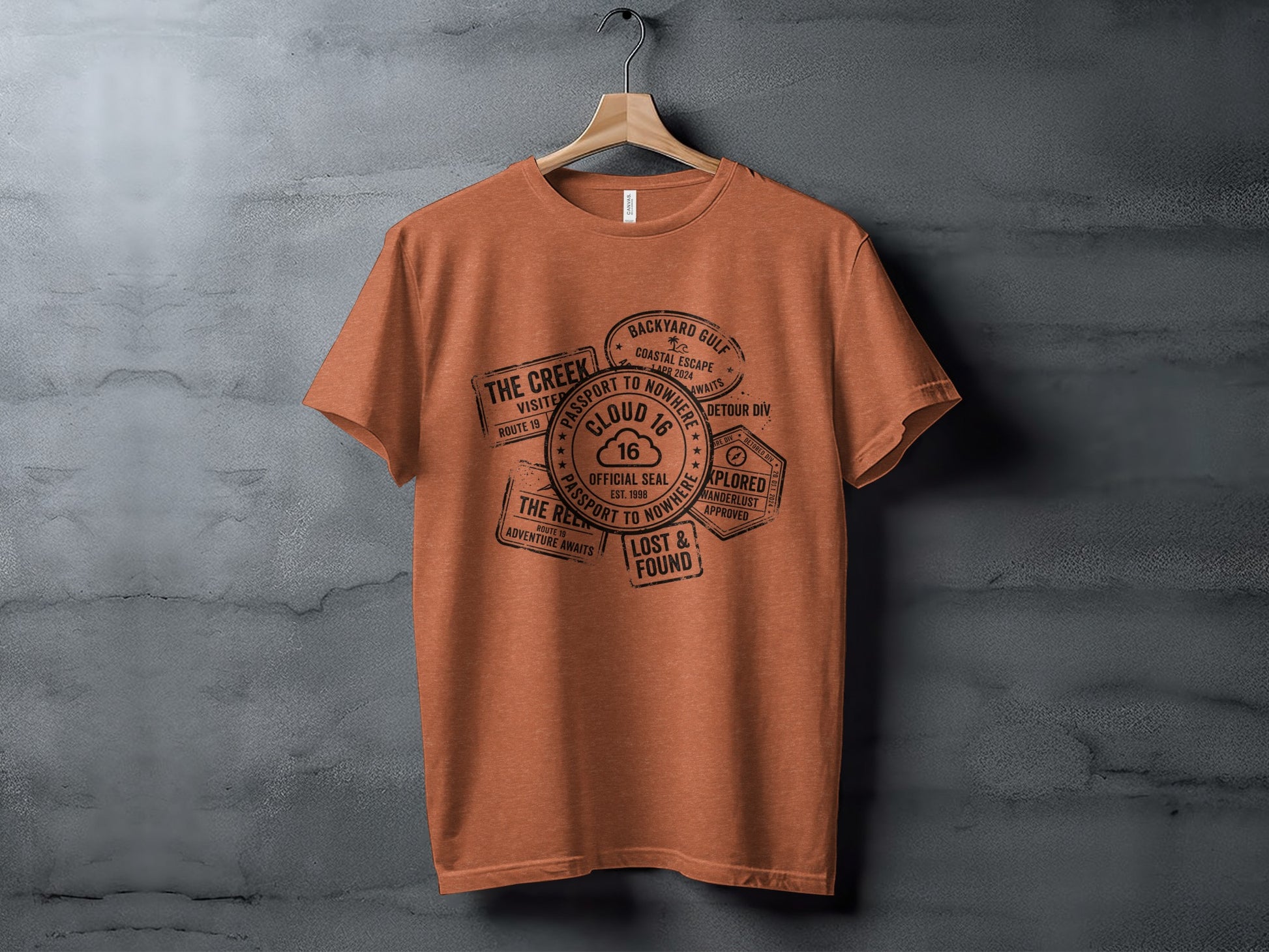 Rugged Wanderlust Passport Stamp Graphic Wilderness Shirt: Orange t-shirt with "Passport to Nowhere" graphic featuring stamps.