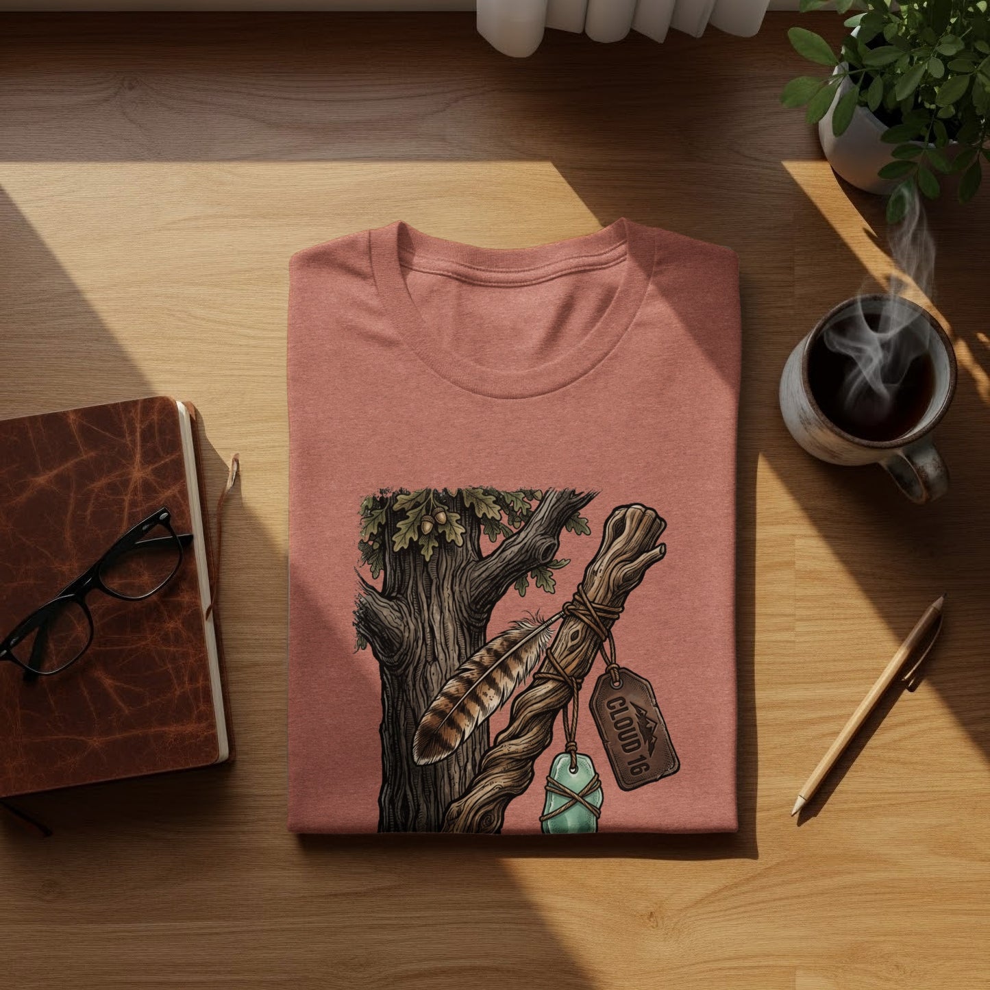 Heritage Walking Stick Spirit: Journey Nomad Tee: Coral t-shirt with tree branch and feather graphic, "Cloud 16" tag.