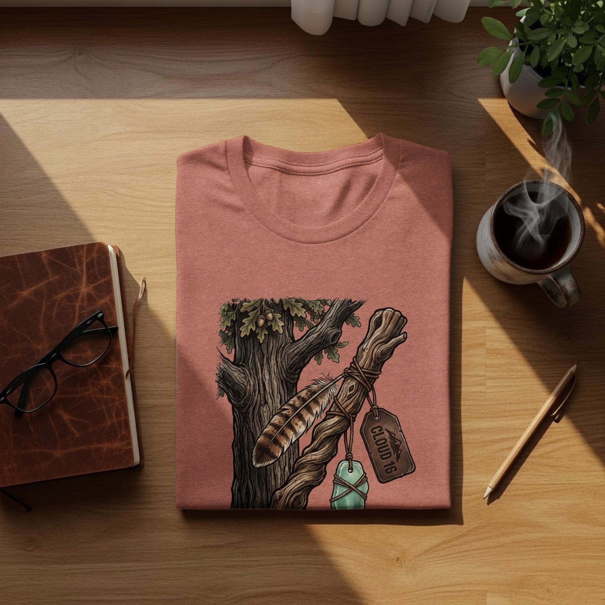 Heritage Walking Stick Spirit: Journey Nomad Tee: Coral t-shirt with tree branch and feather graphic, "Cloud 16" tag.