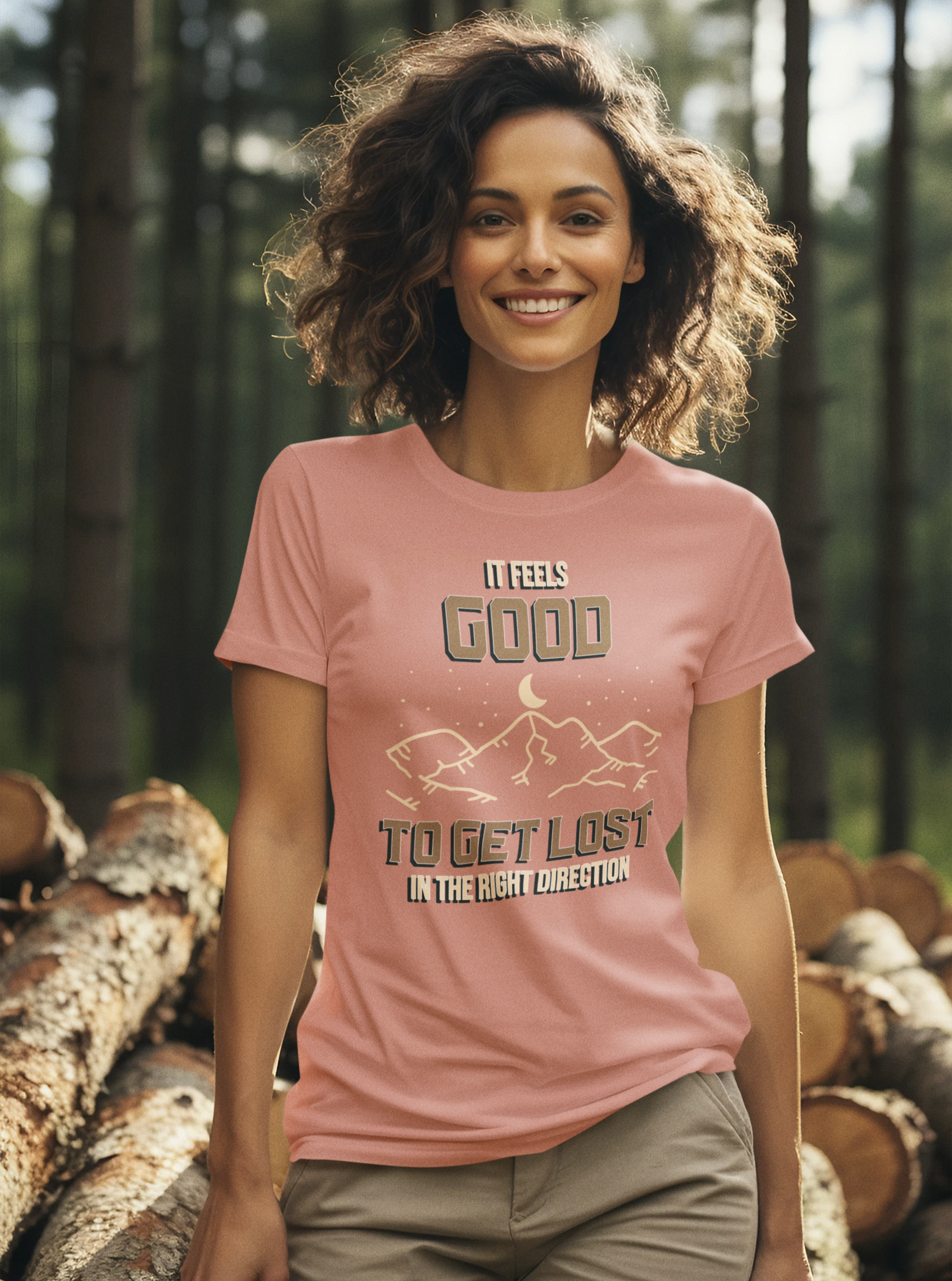 Woman wearing a pink t-shirt with text and graphics in a forest setting