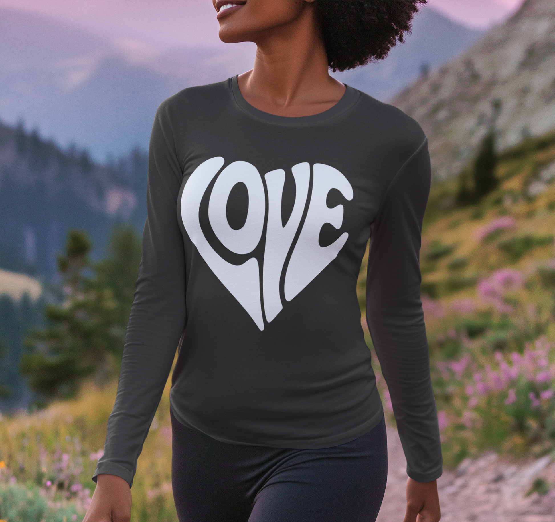 Person wearing a black long-sleeve shirt with 'LOVE' printed in a heart shape outdoors.