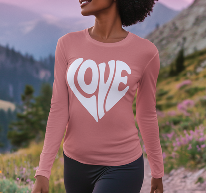 Person wearing a pink long-sleeve shirt with 'LOVE' printed on it against a mountainous landscape.