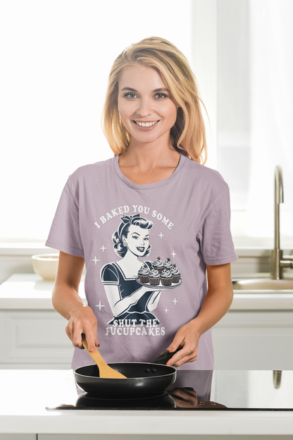 Woman wearing a purple t-shirt with a graphic design in a kitchen.
