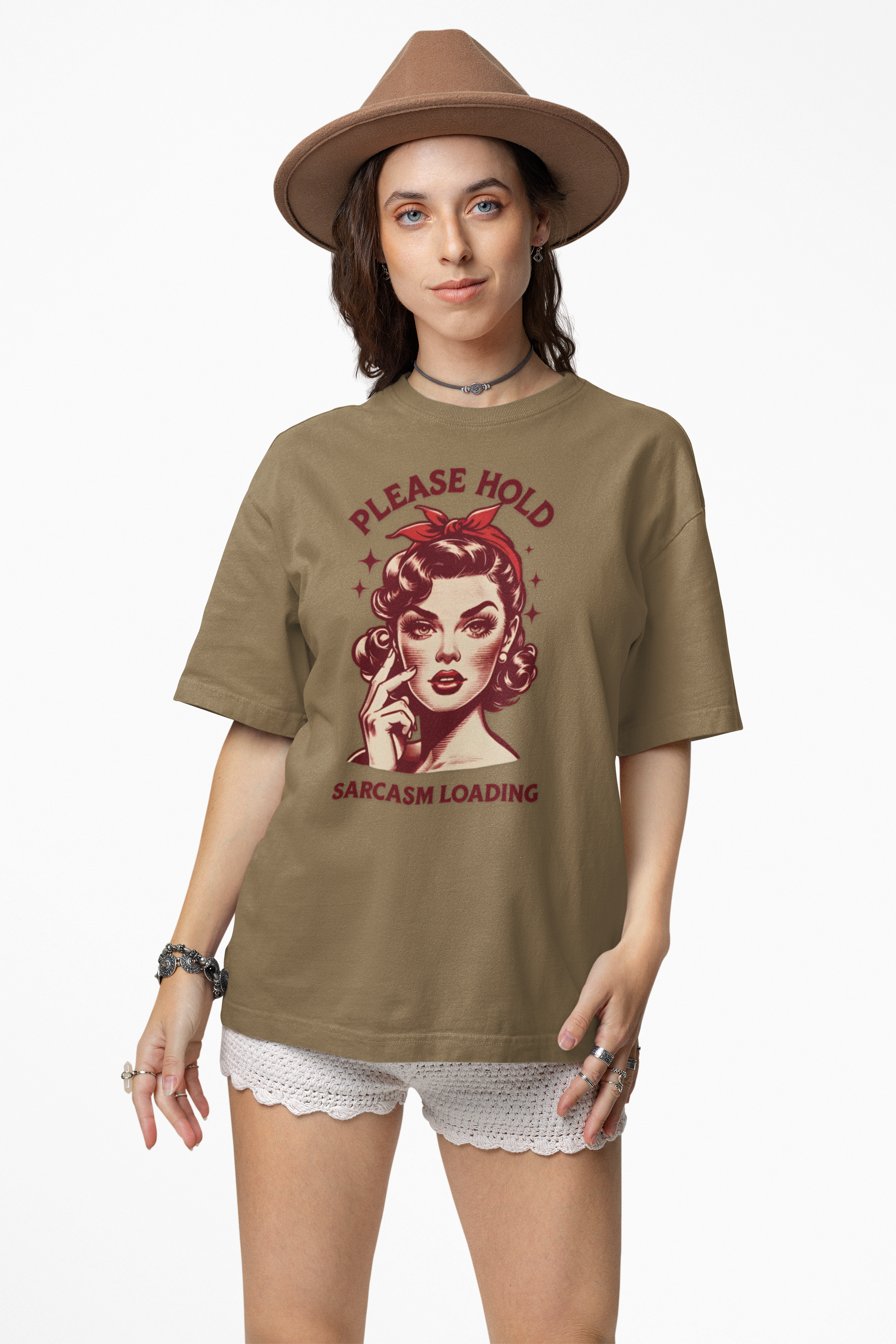 Woman wearing a brown t-shirt with graphic design and text, standing against a white background