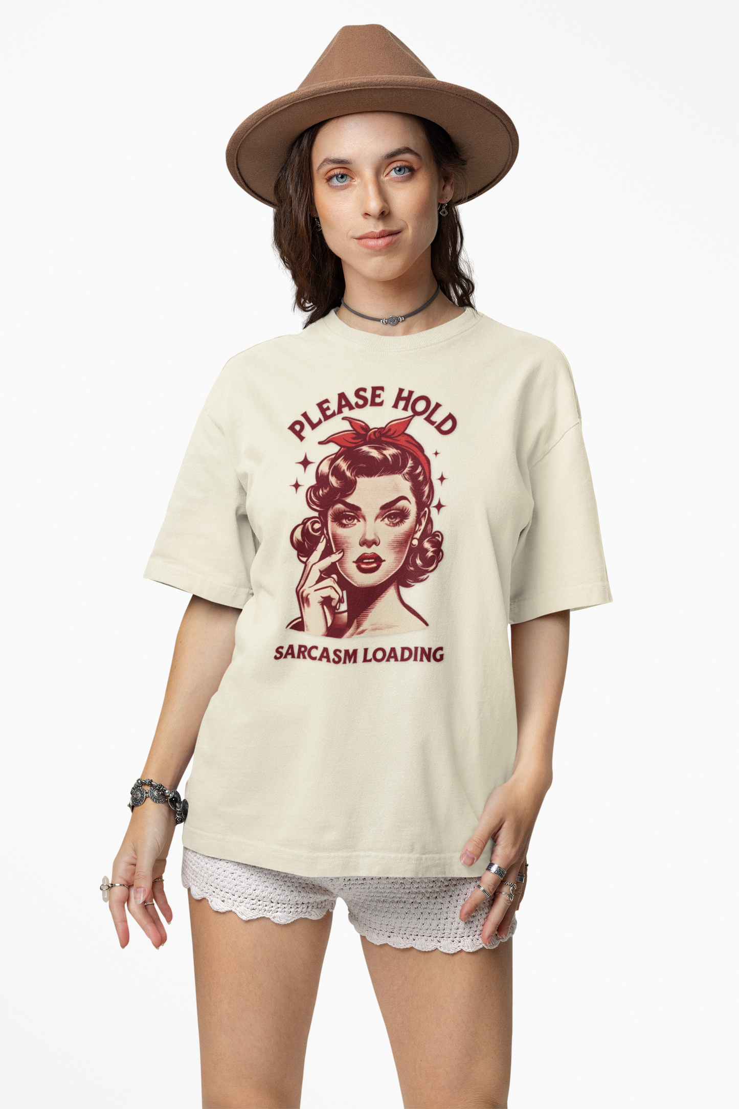 Woman wearing a cream t-shirt with a graphic design and text, standing against a white background.