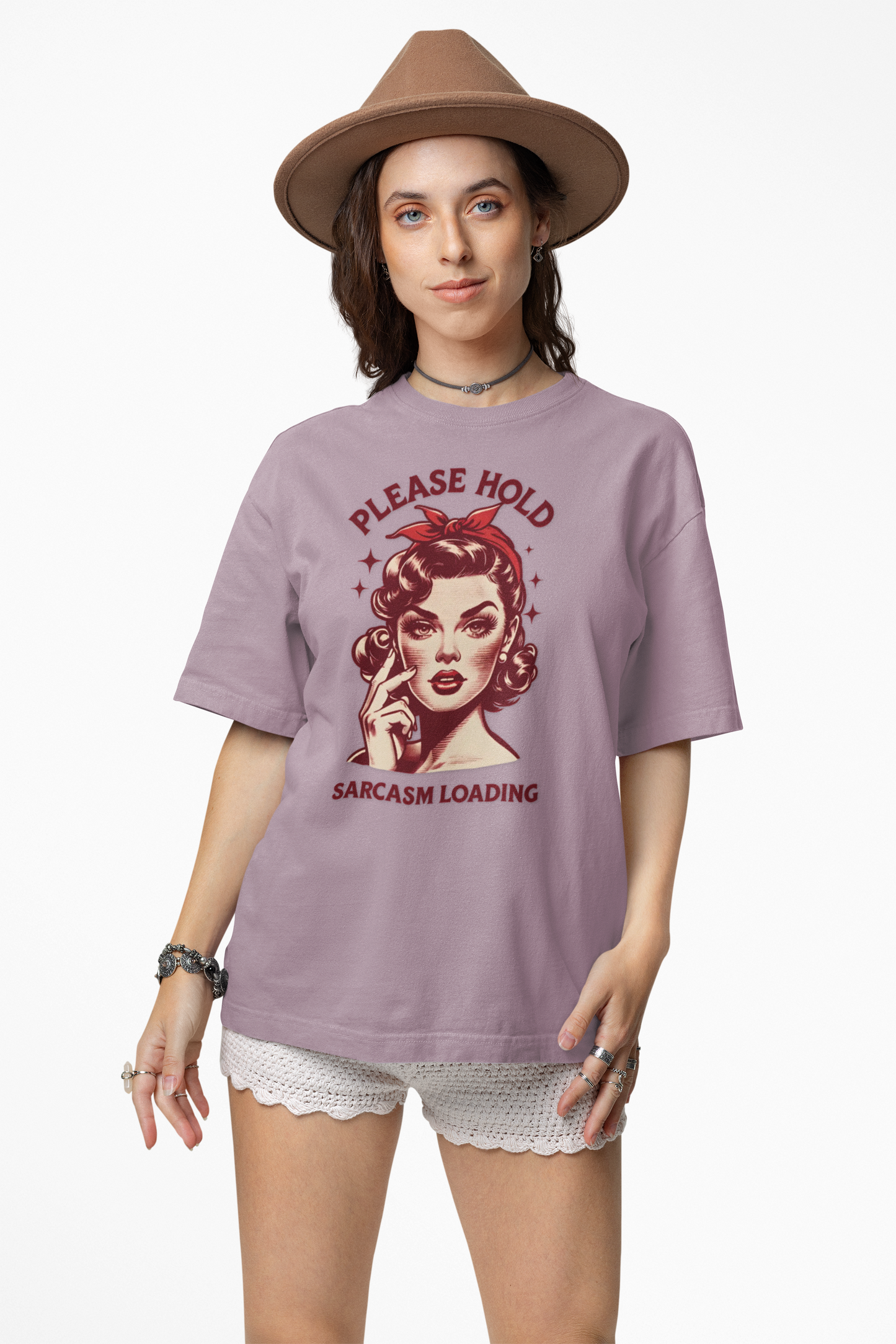 Woman wearing a purple t-shirt with a graphic design and text, standing against a white background