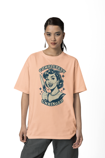 Woman wearing a peach t-shirt with graphic design and text on a white background