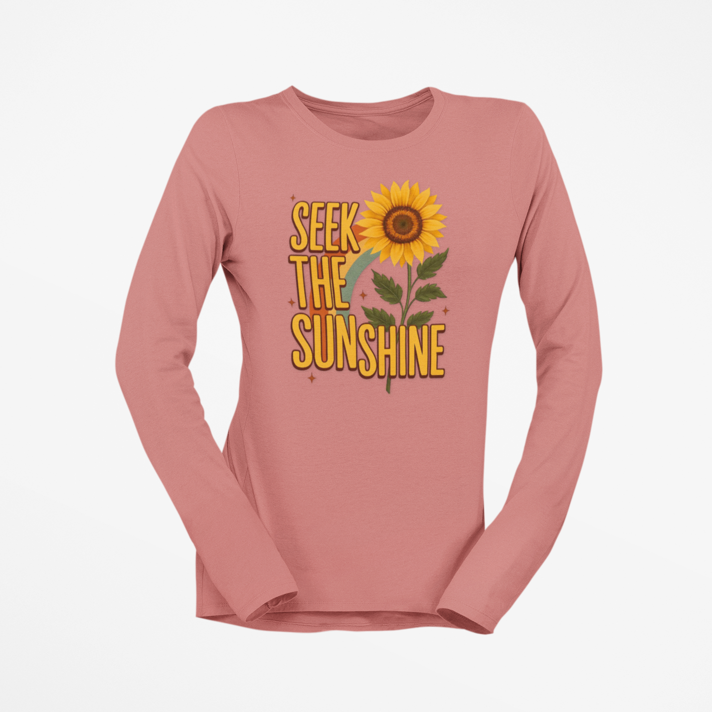 Pink long-sleeve shirt with 'Seek the Sunshine' text and sunflower graphic on a white background