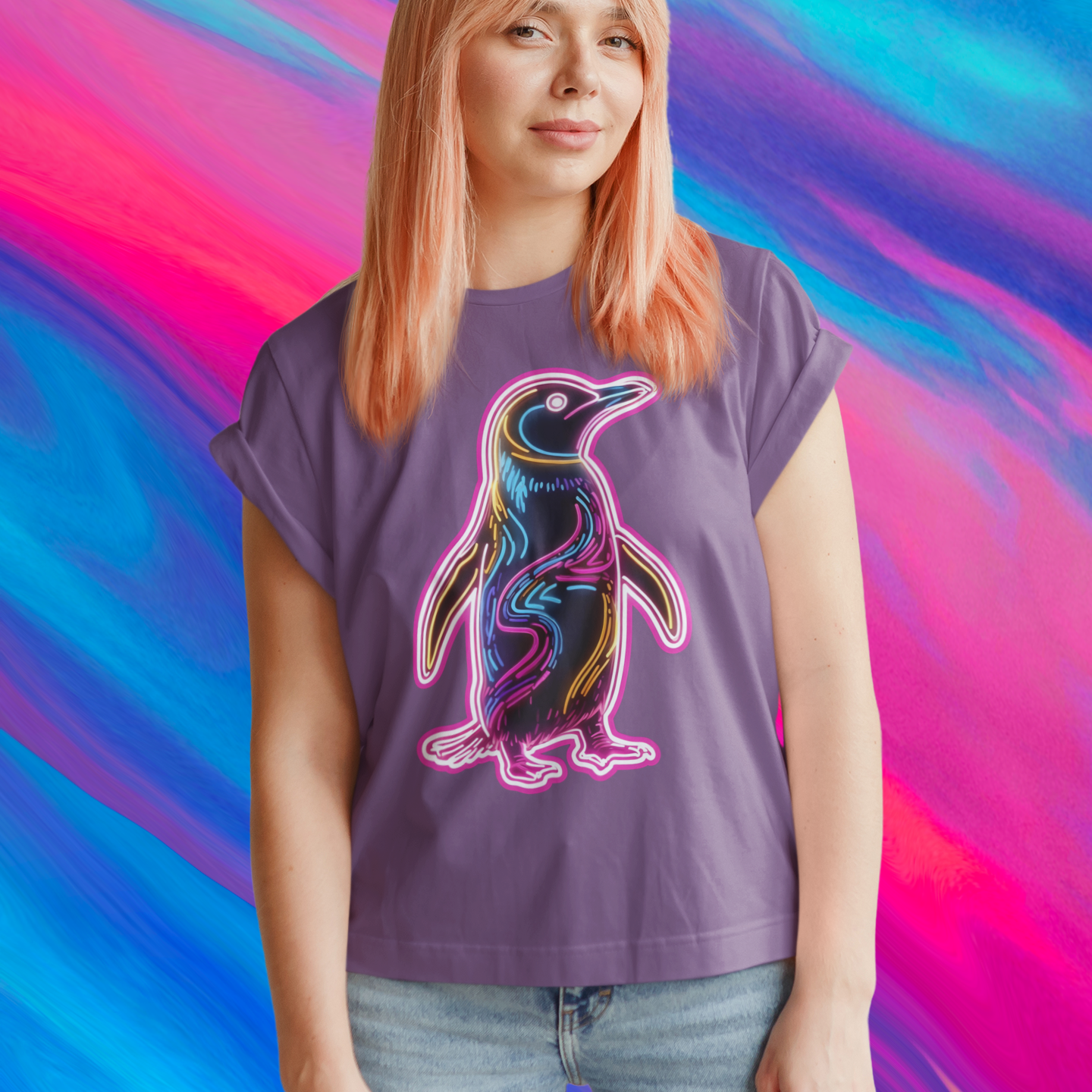 Person wearing a purple t-shirt with a colorful penguin design against a vibrant, multicolored background