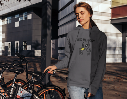 Person wearing a hoodie with a graphic design in an urban setting