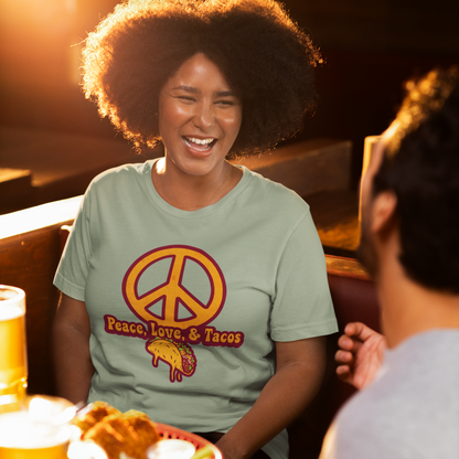 Woman sitting at a bar with a peace sign shirt, smiling at a man.