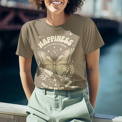 Person wearing a t-shirt with a butterfly design and the word 'Happiness' by a waterfront.