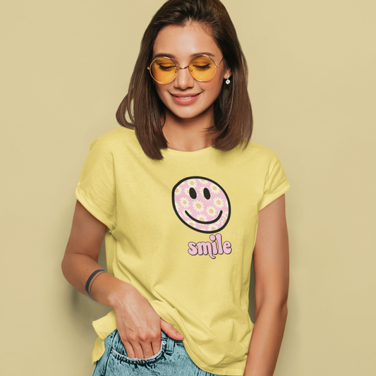 Woman wearing a yellow t-shirt with a smiley face design on a beige background