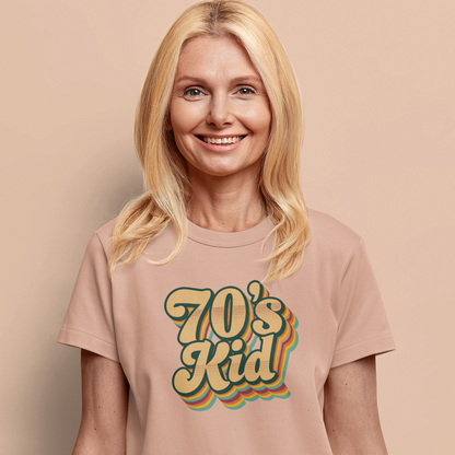 Woman wearing a '70's Kid' t-shirt against a beige background