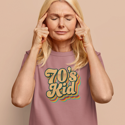 Woman wearing a '70's Kid' t-shirt against a beige background