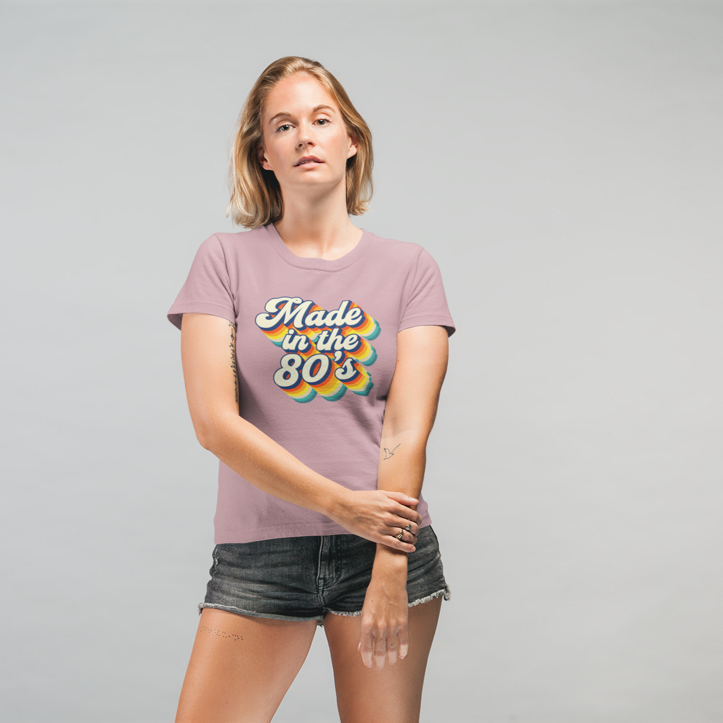 Woman wearing a 'Made in the 80s' t-shirt on a gray background