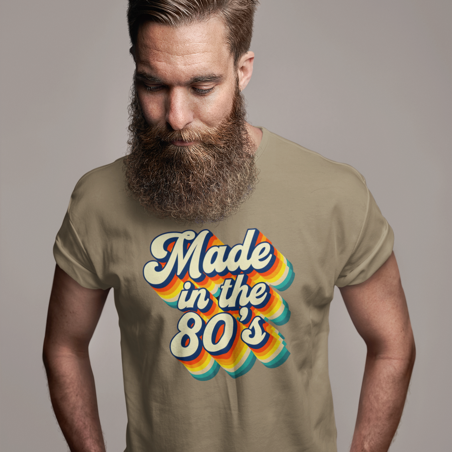 Man wearing a t-shirt with 'Made in the 80s' design on a plain background