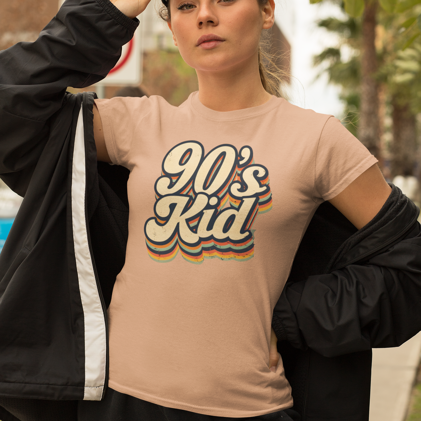 Person wearing a '90s Kid' t-shirt outdoors