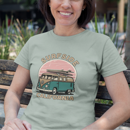 Woman wearing a 'Surfside California' t-shirt with a vintage van design, sitting on a bench outdoors.