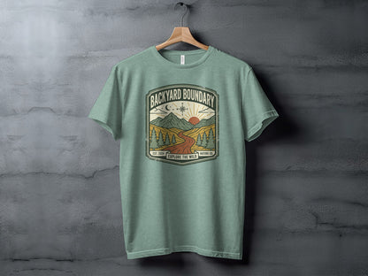Rugged Backyard Boundary: Explore The Wild Wilderness Shirt: Green t-shirt with "Backyard Boundary" and "Explore the Wild" text in a scenic graphic.