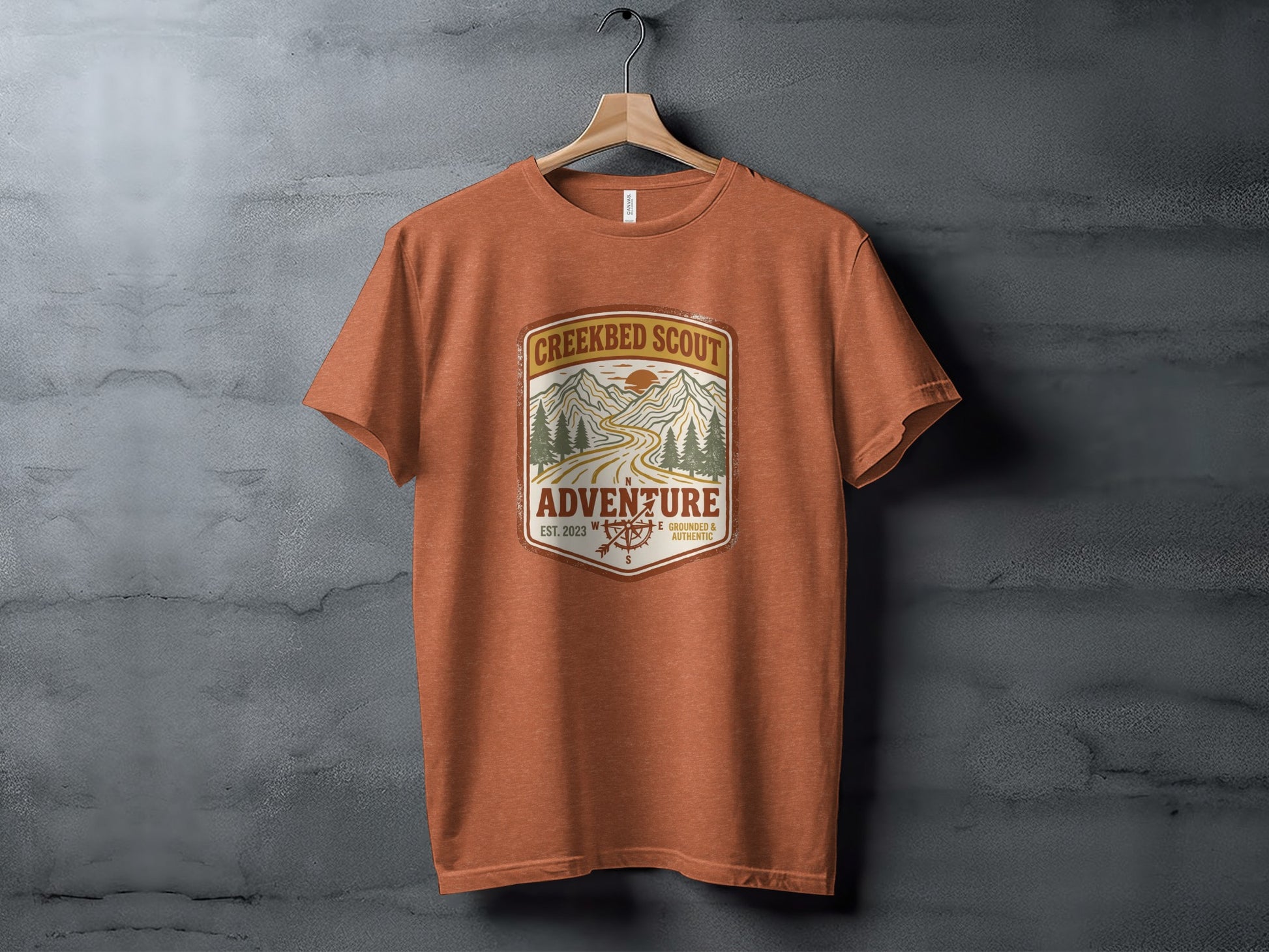 Rugged Creekbed Scout Adventure Emblem Wilderness Shirt: Orange t-shirt with "Creekbed Scout Adventure" graphic.
