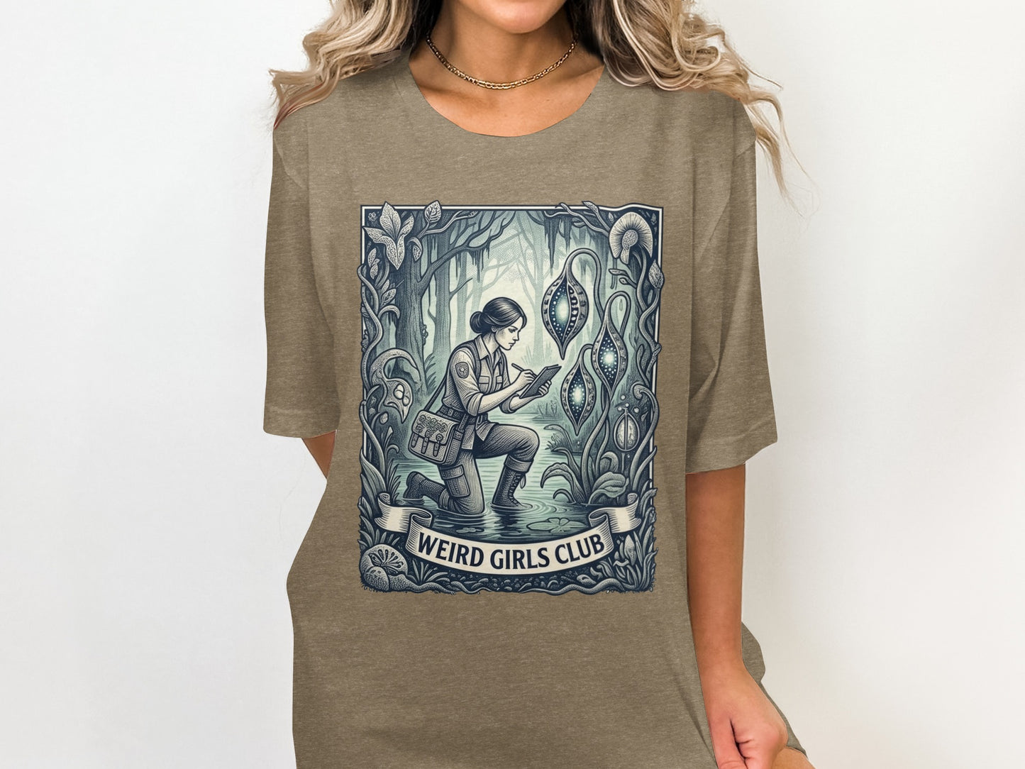T-shirt with "Weird Girls Club" text and illustration of a woman in a forest.