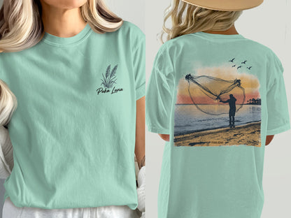 T-shirt with wheat illustration and "Puka Luna" text on front, fishing net scene on back.