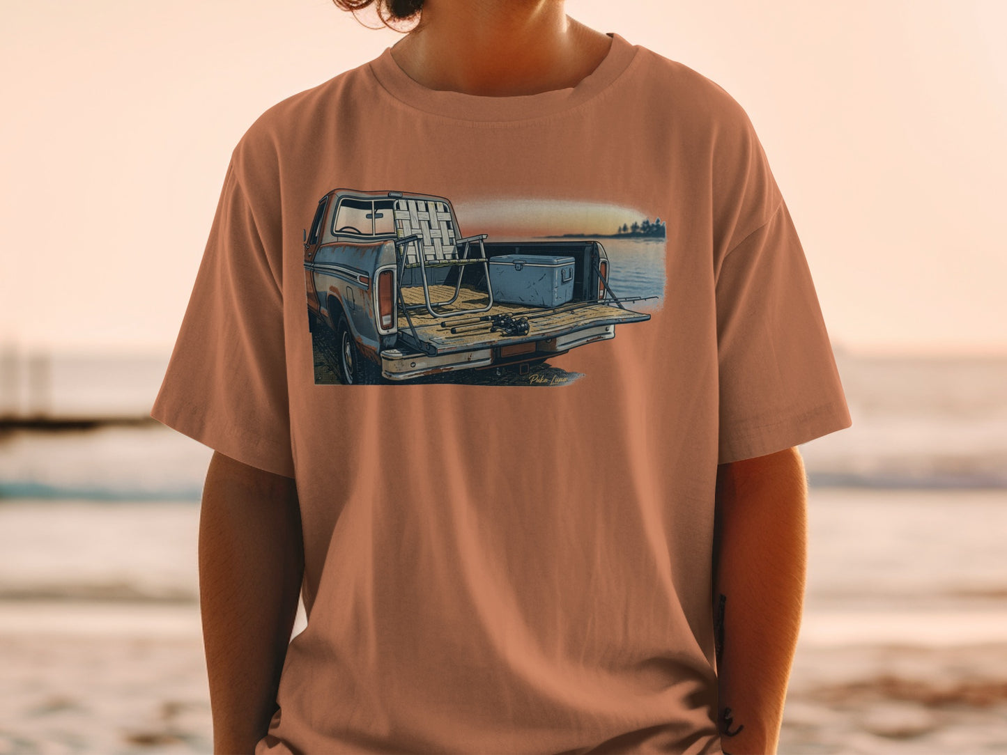 T-shirt graphic of a vintage pickup truck with fishing gear in the bed.