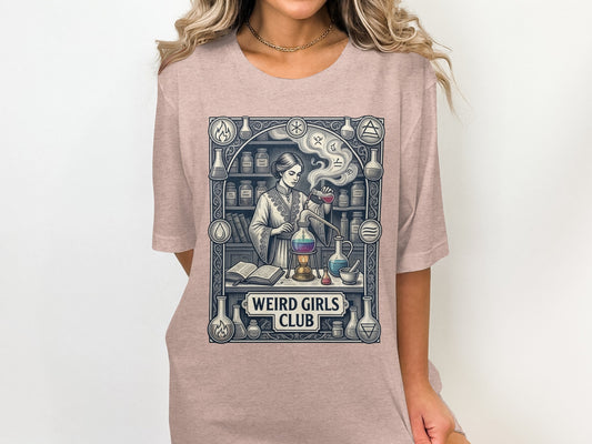 T-shirt graphic of a woman in a laboratory with the text "WEIRD GIRLS CLUB".