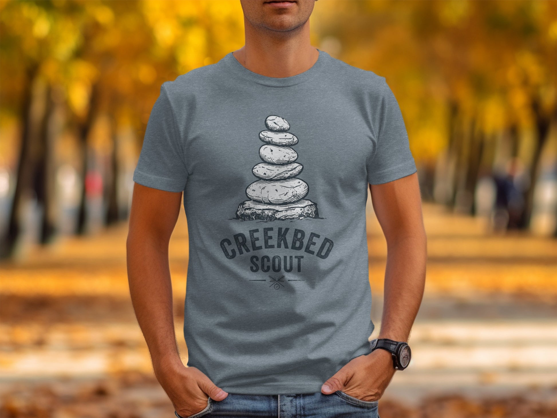 Creekbed Scout Cairn Graphic: The Explorer's Adventure Tee: Grey t-shirt with stacked rocks and "Creekbed Scout" logo.