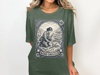 T-shirt graphic of a paleontologist examining a fossil within a circular border.