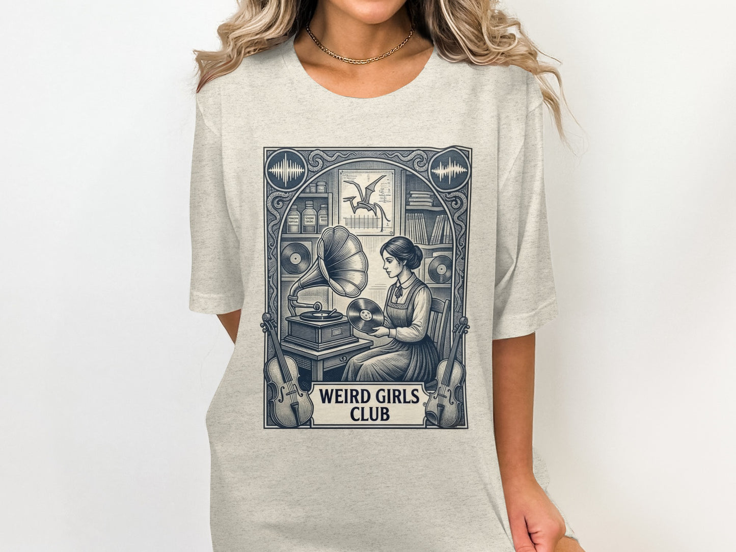T-shirt graphic of a woman at a vintage phonograph, with text "WEIRD GIRLS CLUB".