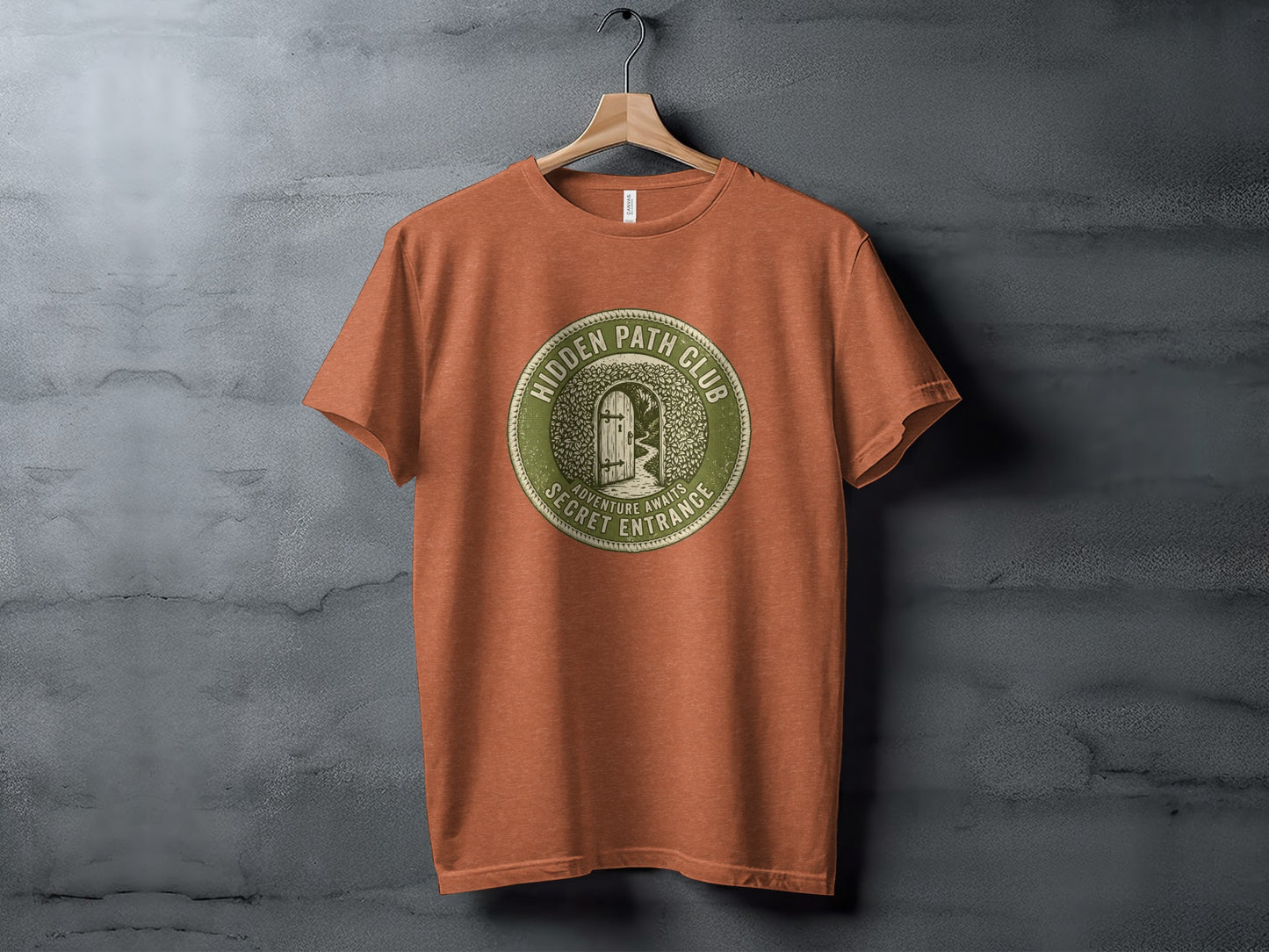 Hidden Path Club: Secret Entrance | Vintage Outdoor Apparel: Orange t-shirt featuring a circular logo with "Hidden Path Club" and a secret entrance graphic.
