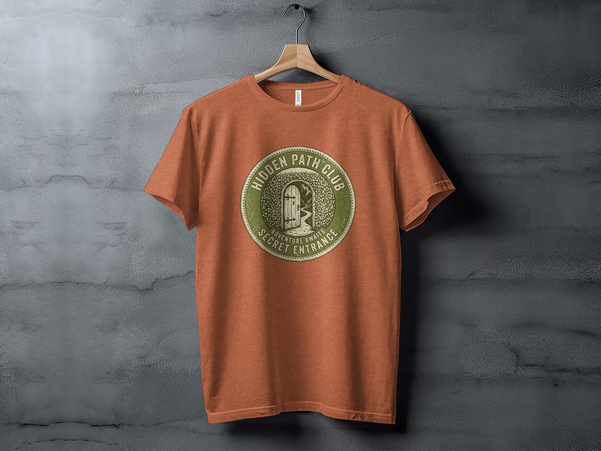 Hidden Path Club: Secret Entrance | Vintage Outdoor Apparel: Orange t-shirt featuring a circular logo with "Hidden Path Club" and a secret entrance graphic.
