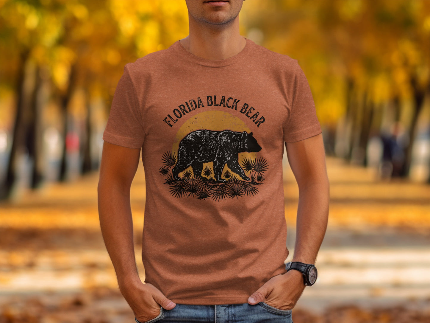 Heritage Florida Bear Trails Classic Nomad Tee: Florida Black Bear graphic on a burnt orange t-shirt, outdoor setting.