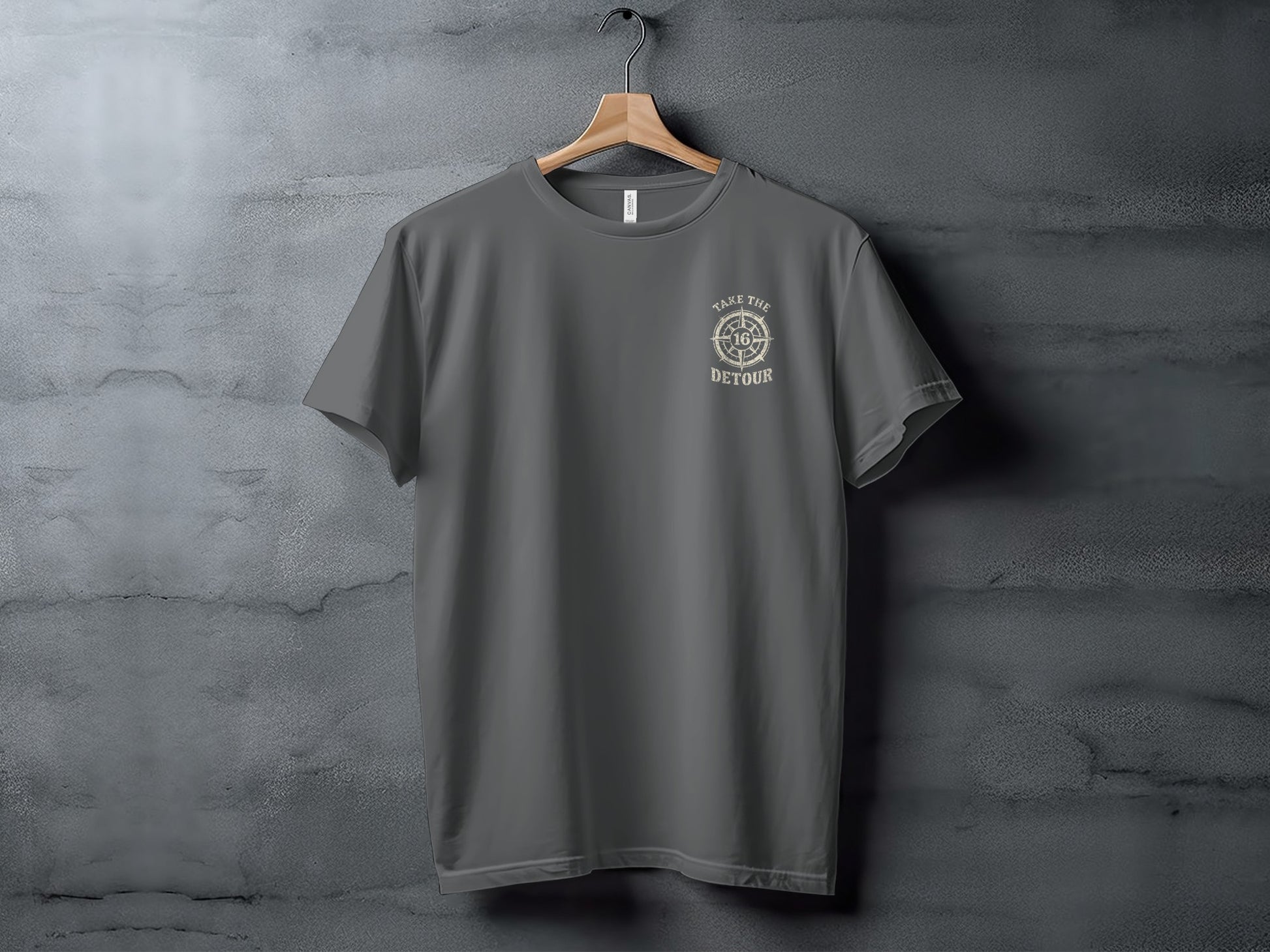 Grey t-shirt with circular compass logo reading "Take the Detour".