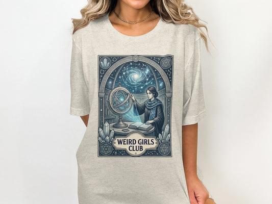 Woman wearing t-shirt with celestial globe and "Weird Girls Club" text.
