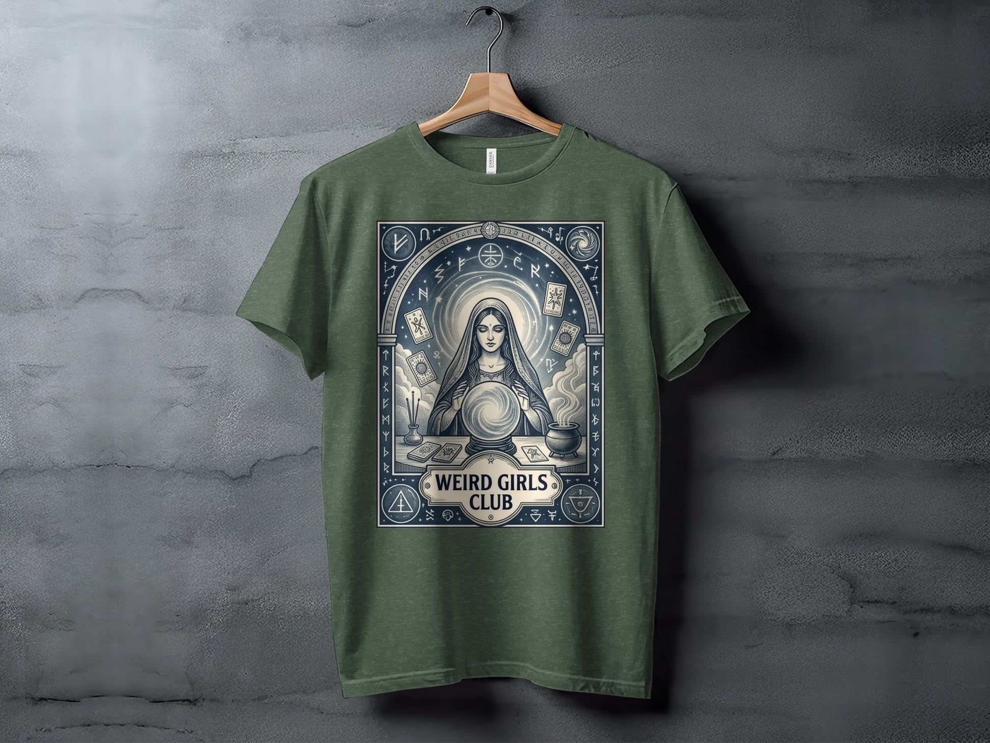 T-shirt featuring mystic woman with crystal ball and runes, "Weird Girls Club" text.