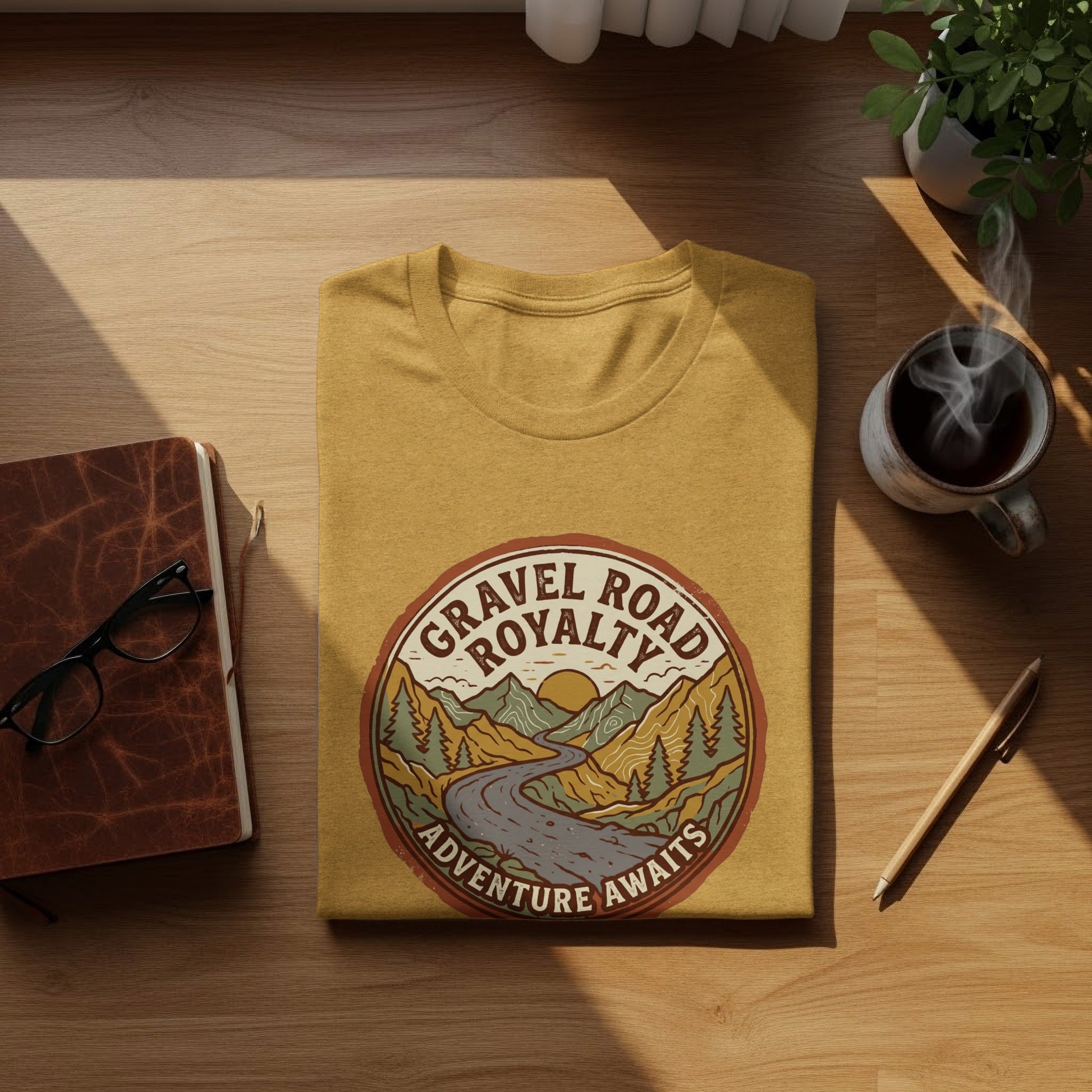 Gravel Road Royalty Vintage Adventure Tee: Backcountry Outpost Shirt: Gravel Road Royalty Adventure Awaits graphic t-shirt on wooden surface.