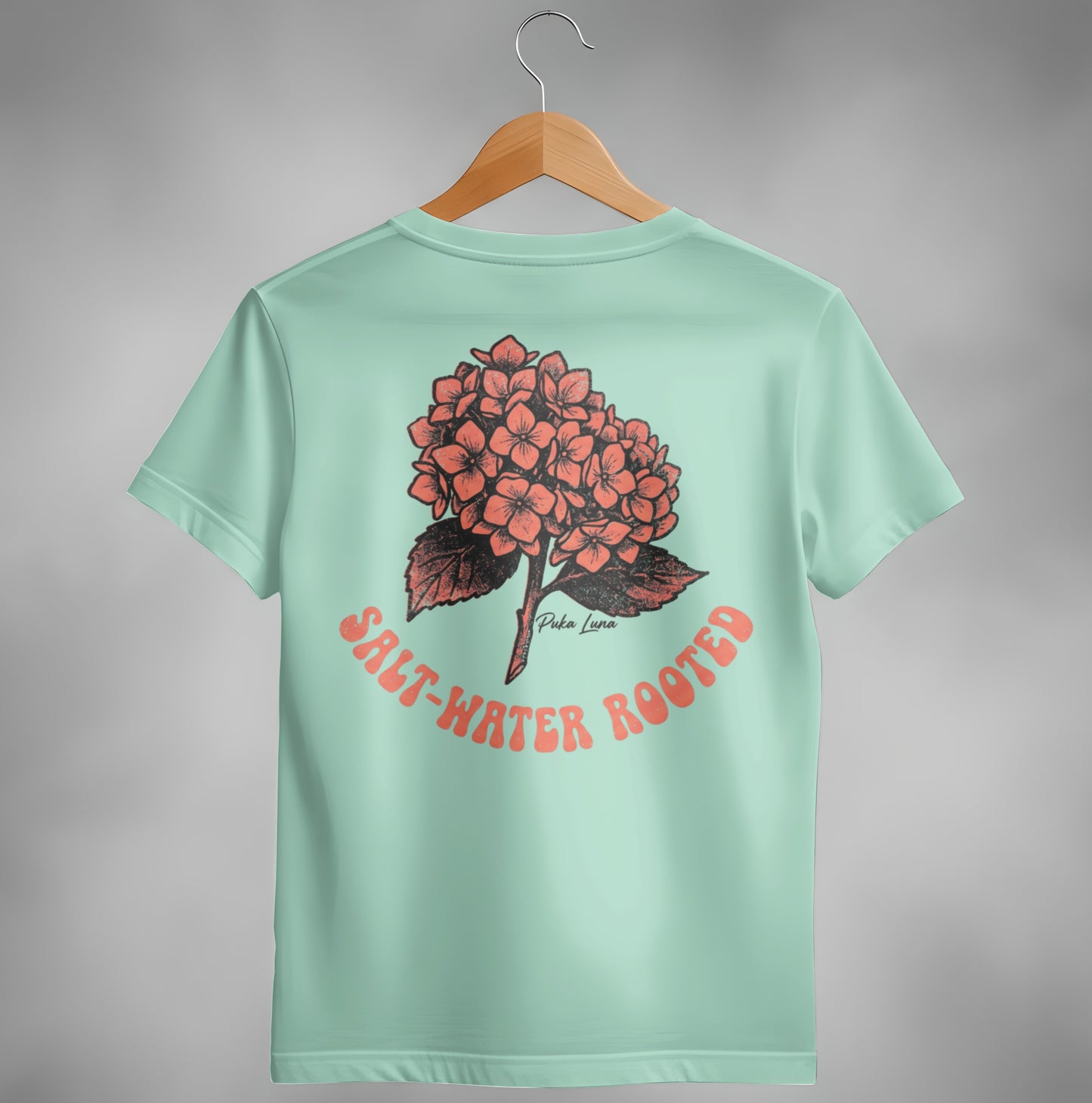 Mint t-shirt with coral hydrangea graphic and "Salt-Water Rooted" text.