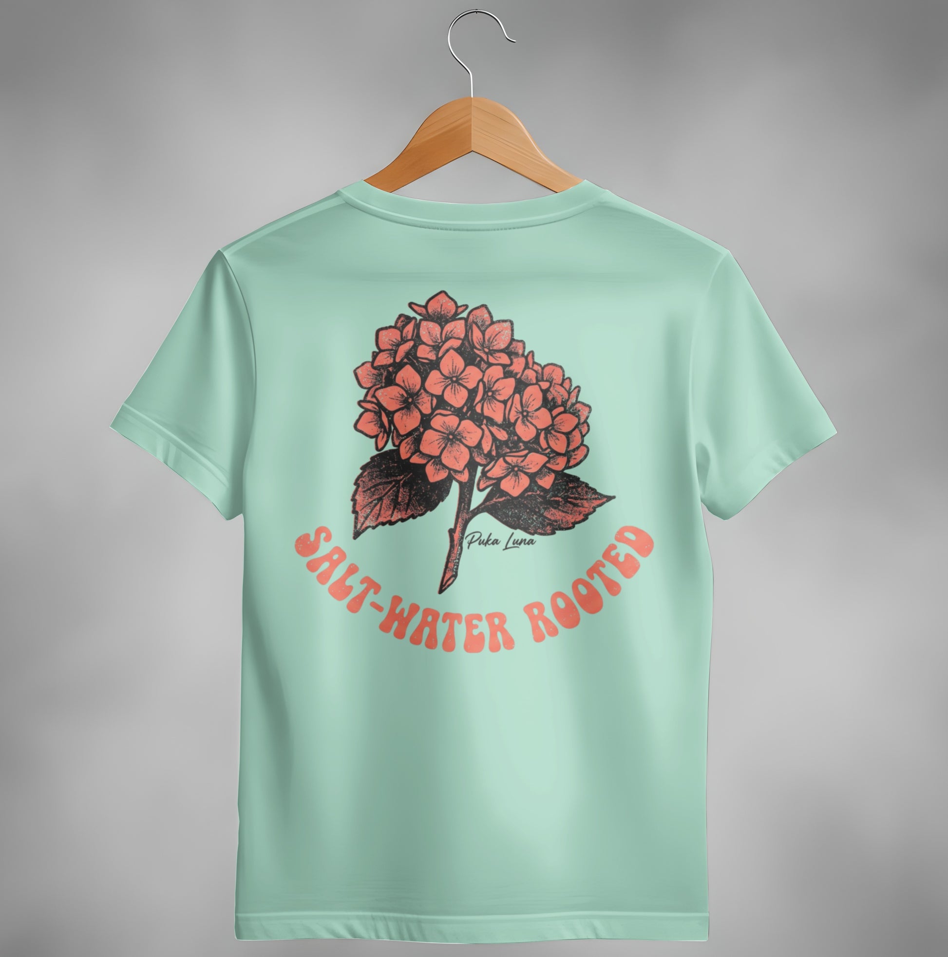 Mint t-shirt with coral hydrangea graphic and "Salt-Water Rooted" text.