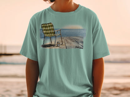 T-shirt featuring a graphic of a beach chair and can on a pier.