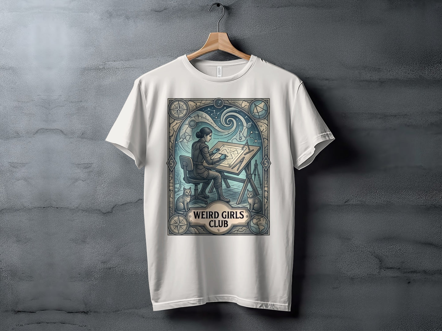 White t-shirt with intricate art nouveau design featuring a woman drawing at a desk and "WEIRD GIRLS CLUB".