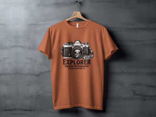 The Analog Explorer's Detour: Backcountry Outpost Shirt: Orange t-shirt with vintage camera graphic and text "Explorer Vintage Photography Analog Adventure Co."