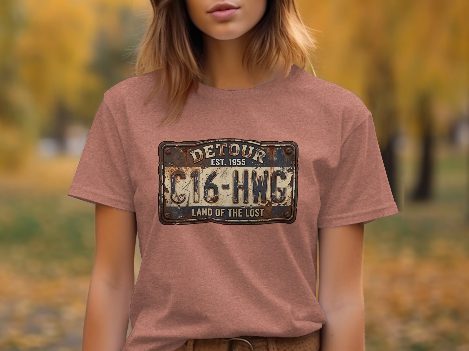 Land of the Lost Detour Plate: The Explorer's Adventure Tee: Rusting license plate graphic with "DETOUR EST. 1955 C16-HWG LAND OF THE LOST" on a t-shirt.