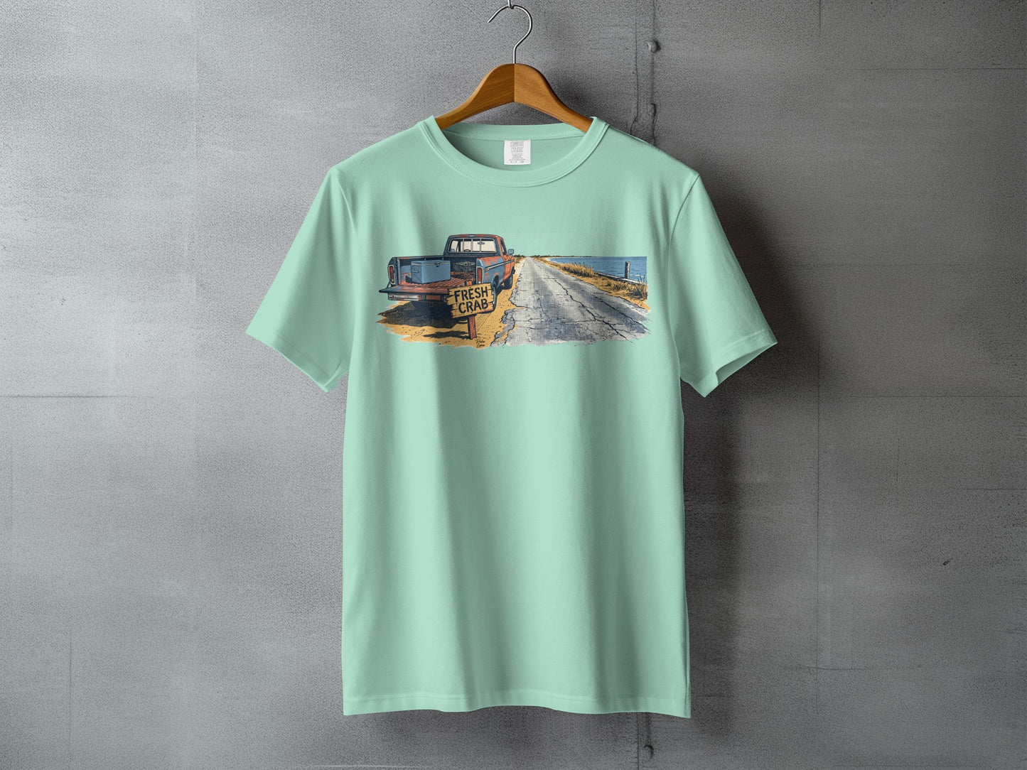 Pale blue t-shirt featuring a distressed graphic of a rusty truck and "FRESH CRAB" sign.